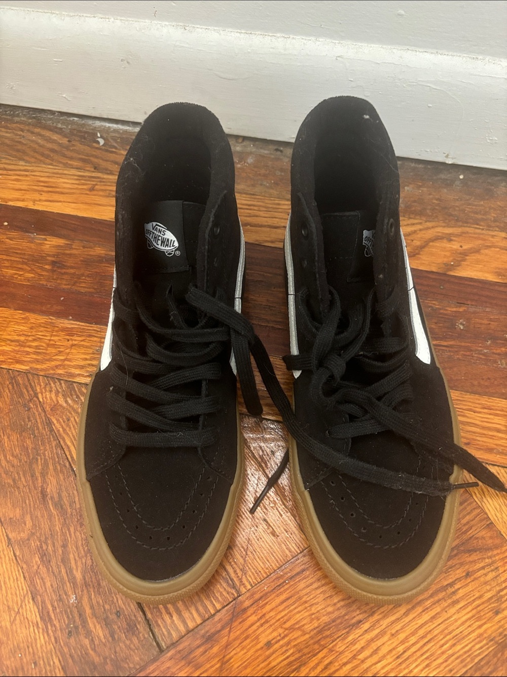 Black canvas vans hightops with brown rubber soles and white logo+ racing detail